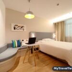 Hotel room with a laptop, booked after comparing discount codes
