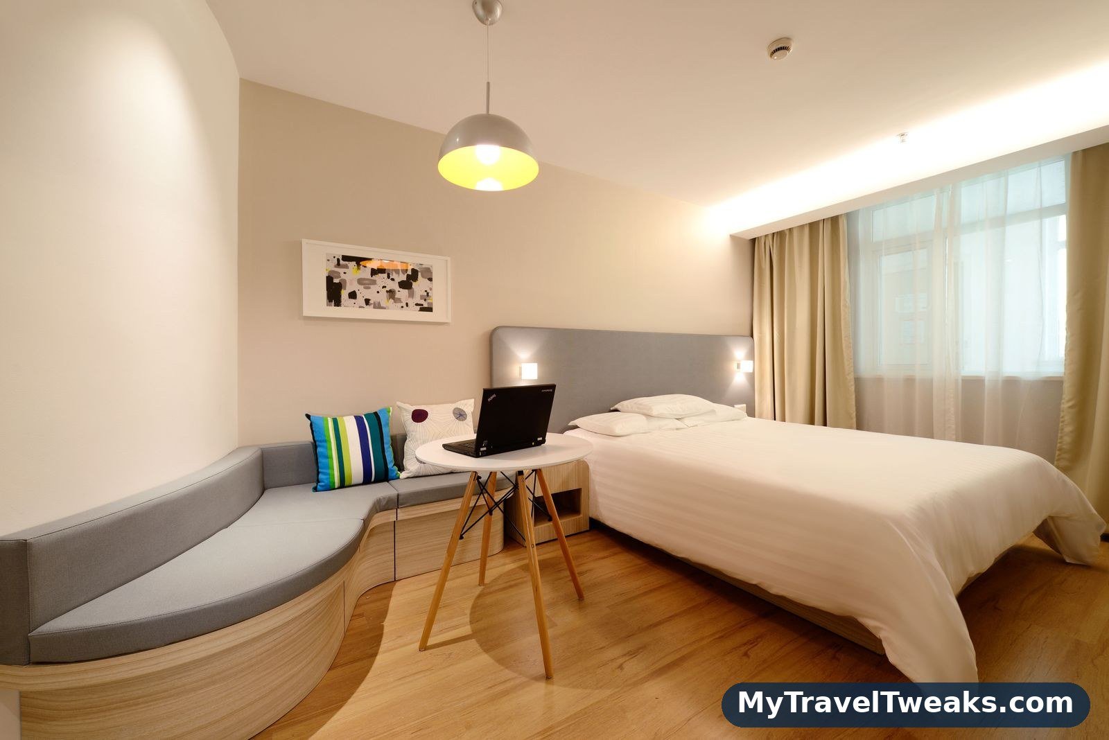 Hotel room with a laptop, booked after comparing discount codes