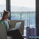 Comparing hotel offers on a laptop in a hotel lounge
