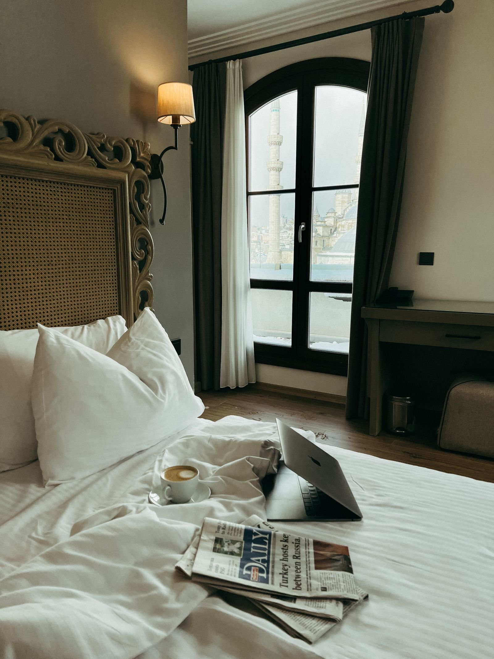 Luxury hotel bedroom with a city view