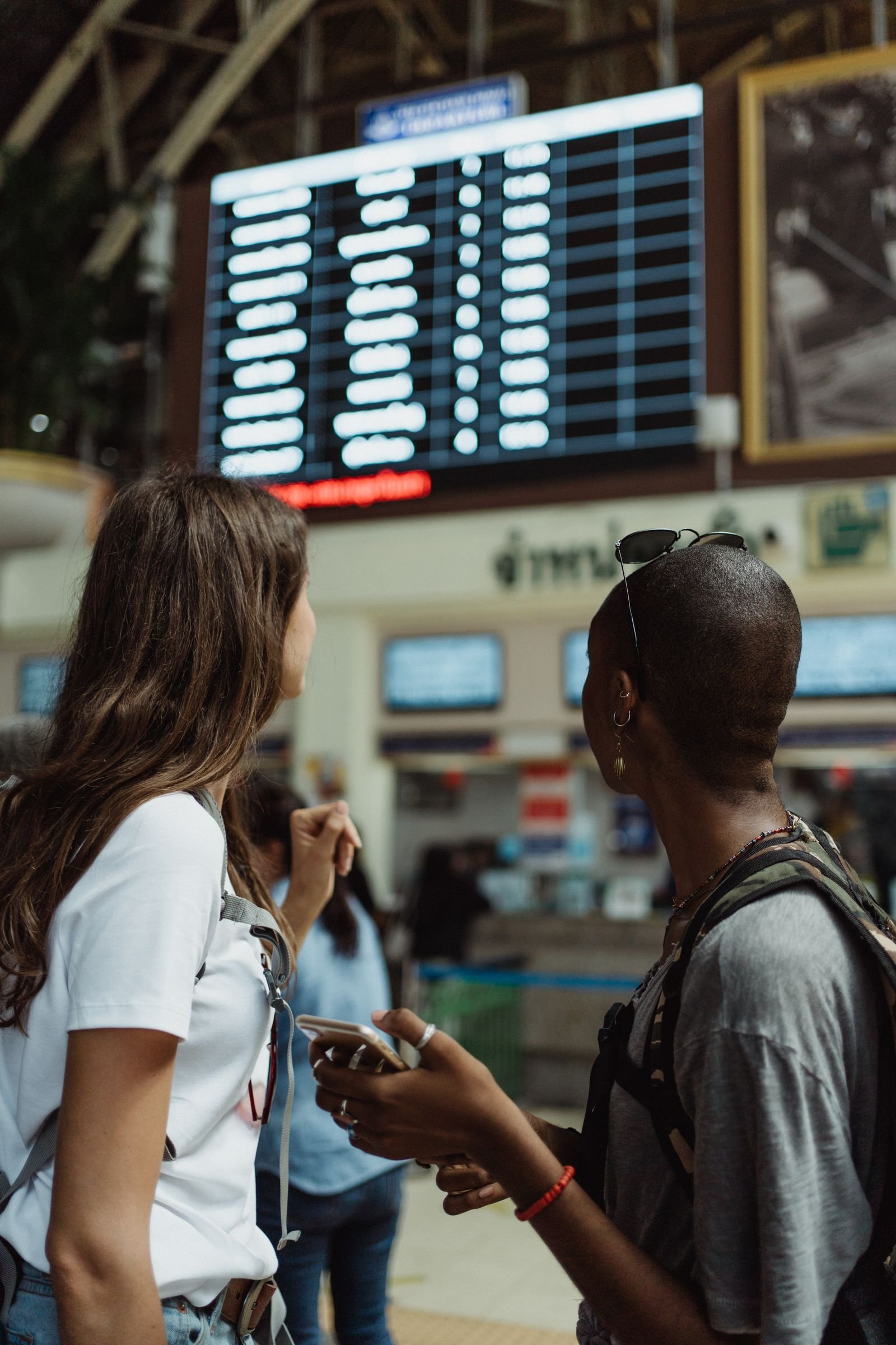 Travellers checking flight information at the airport